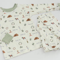 personalized He is Risen Easter PJs with Biblical Easter images on a white stretchy knit fabric, perfect for babies toddlers and big kids.