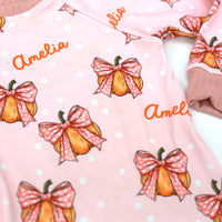 Halloween nightwear for kids with cartoon pumpkins and pink bows