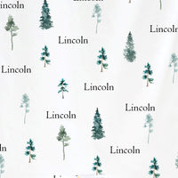 a repeating pattern of stylized pine trees and the word "Lincoln" written in various fonts and sizes.