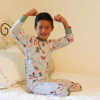 Boy flexing while wearing Ski Pajamas.