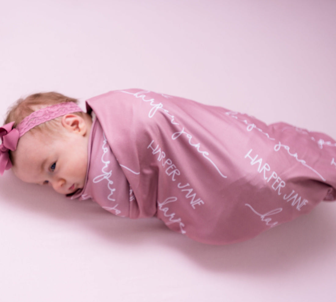 Baby swaddle Personalized swaddle Stretchy fabric Baby shower gift Minimalist design Solid color Nursery decor Newborn essential Breathable material Coordinating prints Soft touch Comfortable sleep Custom baby blanket