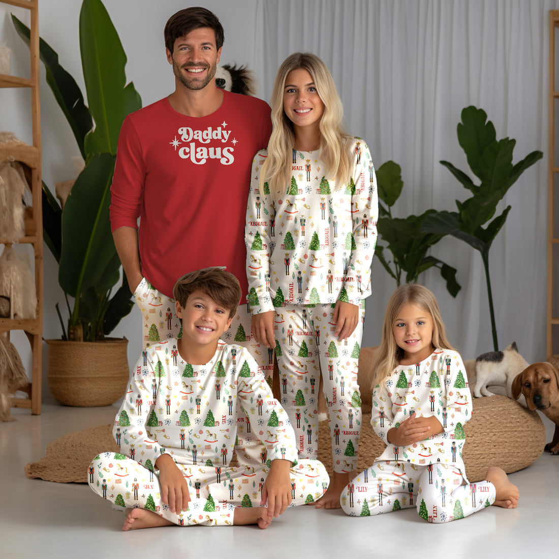 little boys wearing personalized Christmas pajamas featuring classic nutcracker images along with kid's name on white material and red cuffs.