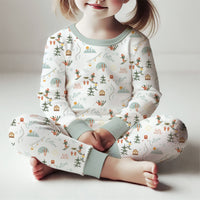 Young girl sitting and wearing Ski Pajamas.