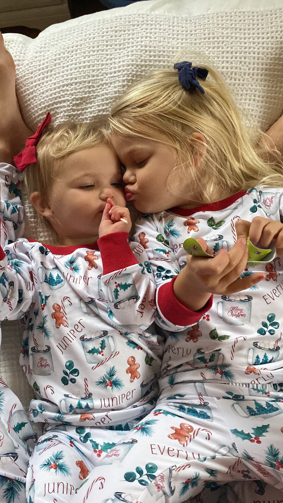 Two children wearing matching hot cocoa christmas pajamas