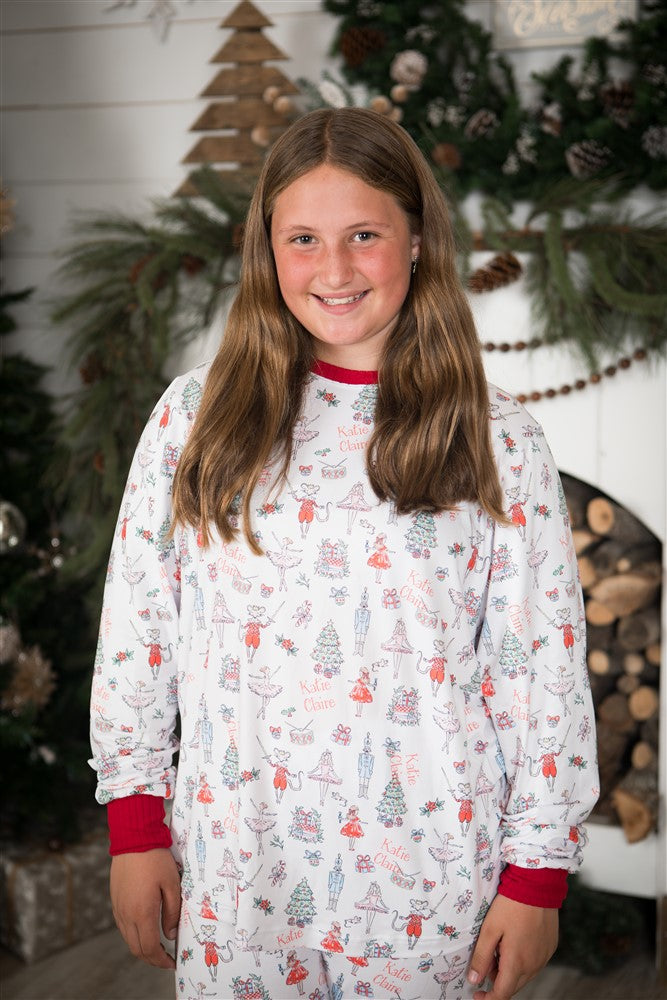 Teen girl wearing Modern Nutcracker Holiday Pajamas for women, modern minimalistic images from the Nutcracker ballet on white knit fabric and red cuffs, matching Christmas jammies for families.