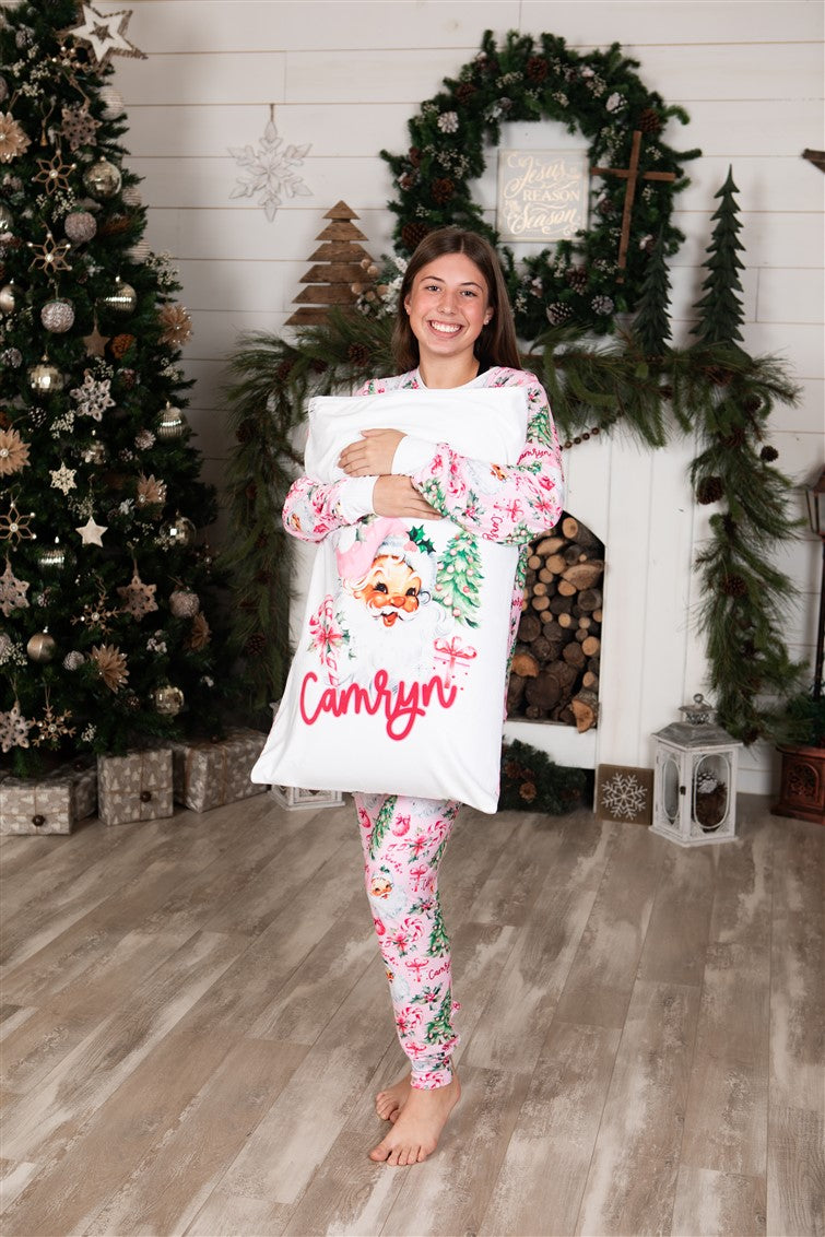 Minky fabric Christmas pillowcase for girls with vintage Santa face and pink accents and kid's name in red script font.