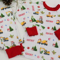Construction Christmas Pajamas set (top and bottoms) personalized with a child's name in red font.