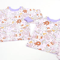 cute easter sleepwear for kids, girl Easter pajamas with bunny shaped sweet treats on a lavender stretchy background.