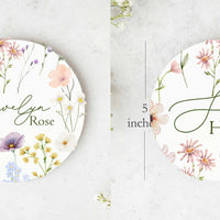 She's Here an Name on a beautiful wildflower baby girl disk for announcing birth.