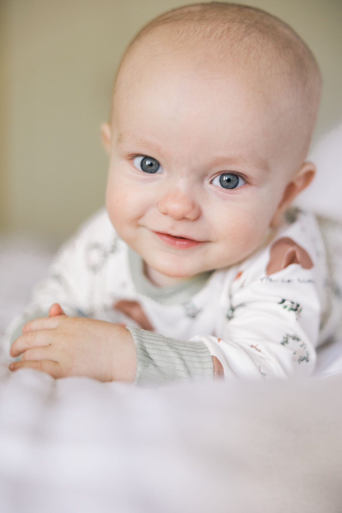 Personalized Kids Pajamas Custom Made, baby wearing personalized He is Risen Easter PJs with Biblical Easter images on a white stretchy knit fabric, perfect for babies toddlers and big kids.