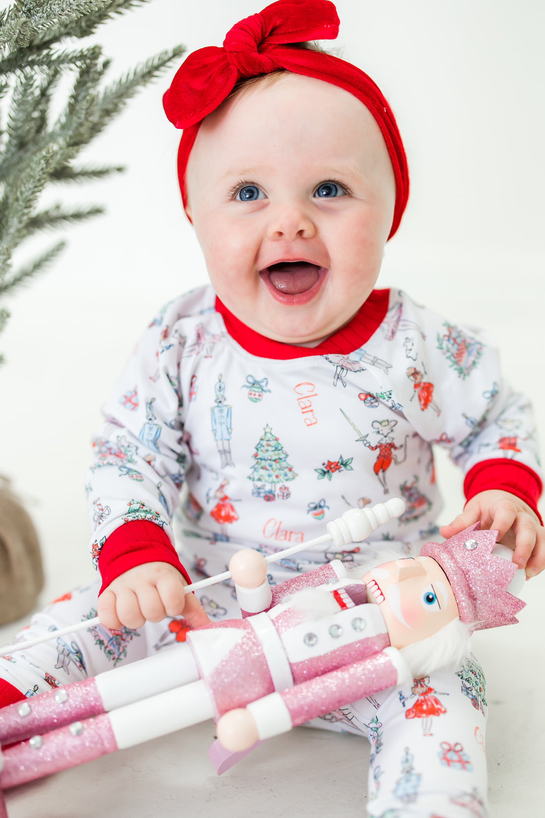 baby smiling while wearing personalized Nutcracker pajamas.