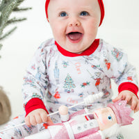 baby smiling while wearing personalized Nutcracker pajamas.