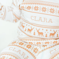 Little baby wearing personalized striped Christmas pajamas.