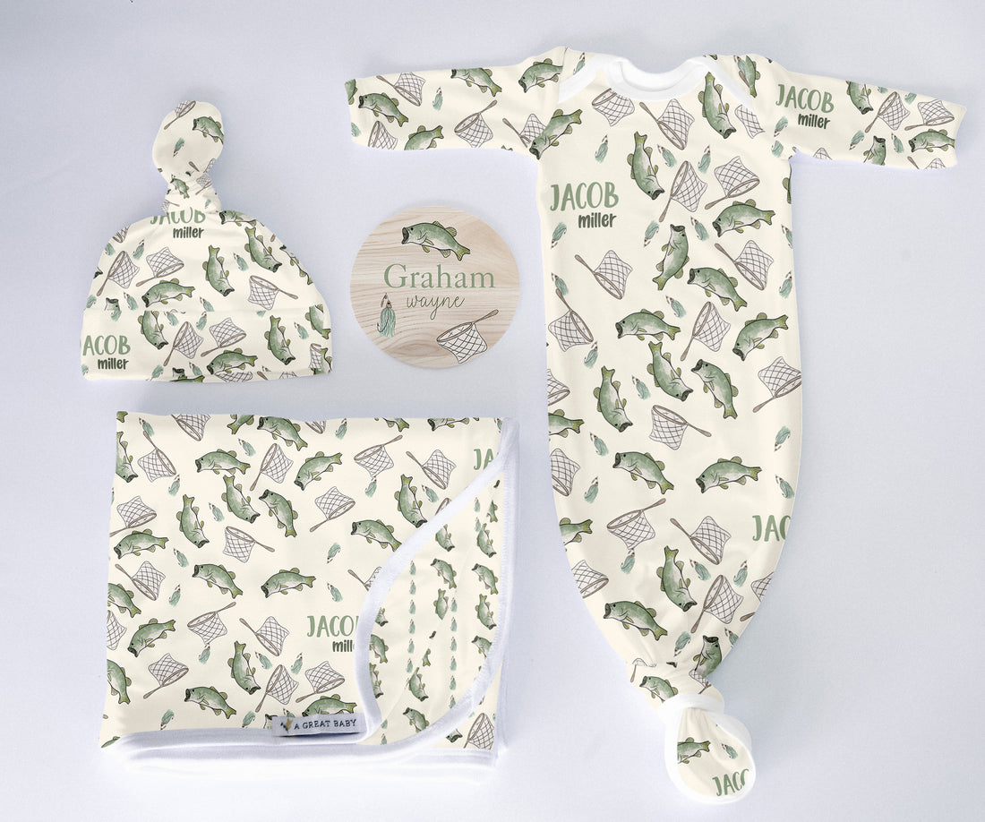 Baby clothing set with hat, blanket, and onesie featuring fish patterns on a light gray background.