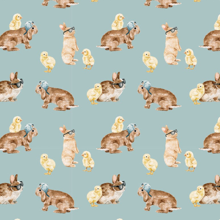 kid's Easter bunny pajamas with chicks and rabbits on a teal background.