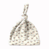 A white baby hat with a pattern of small crabs printed on it.
