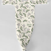 Baby onesie with fish and fishing rod pattern on a white background