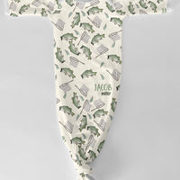 Baby onesie with fish and fishing rod pattern on a ivory background