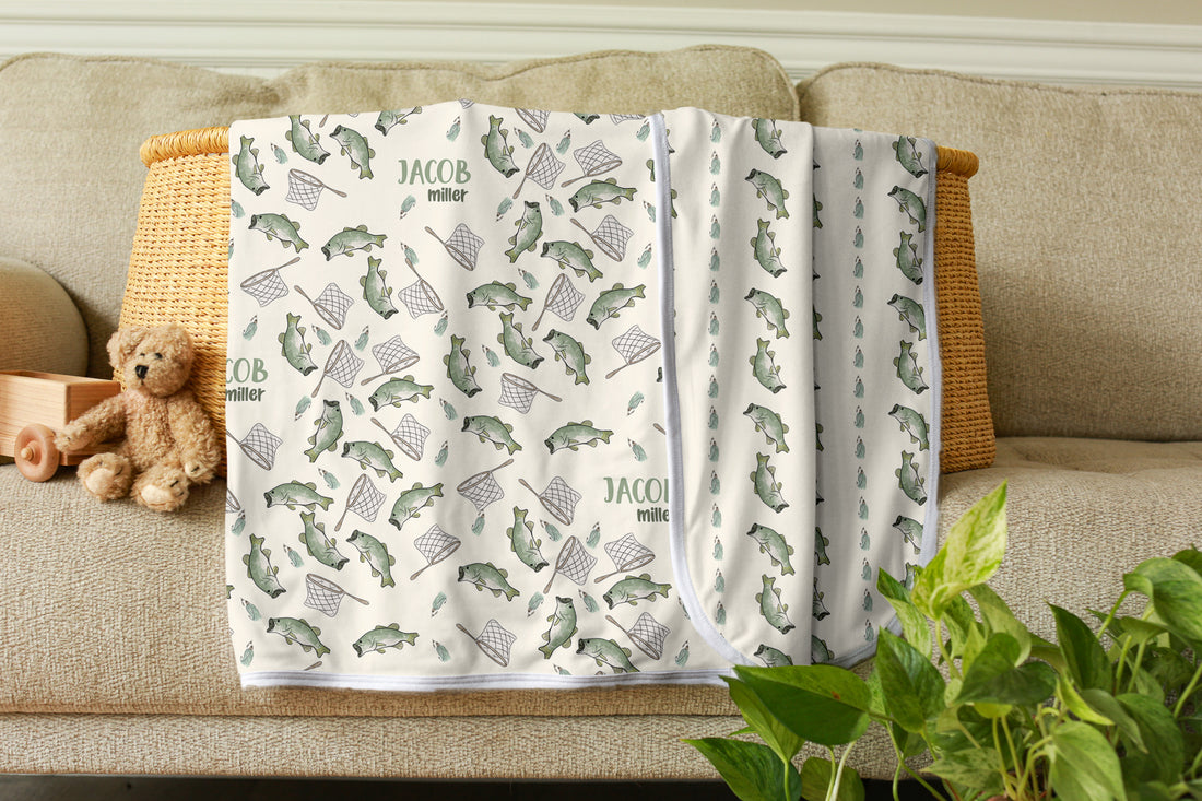 Baby blanket with bear pattern on a couch with a teddy bear and plant