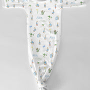 Baby onesie with Peter Rabbit character print and baby's name text on a white fabric background
