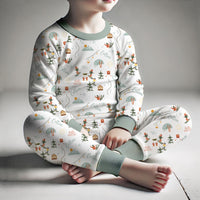 Boy sitting down and wearing personalized ski pajamas.