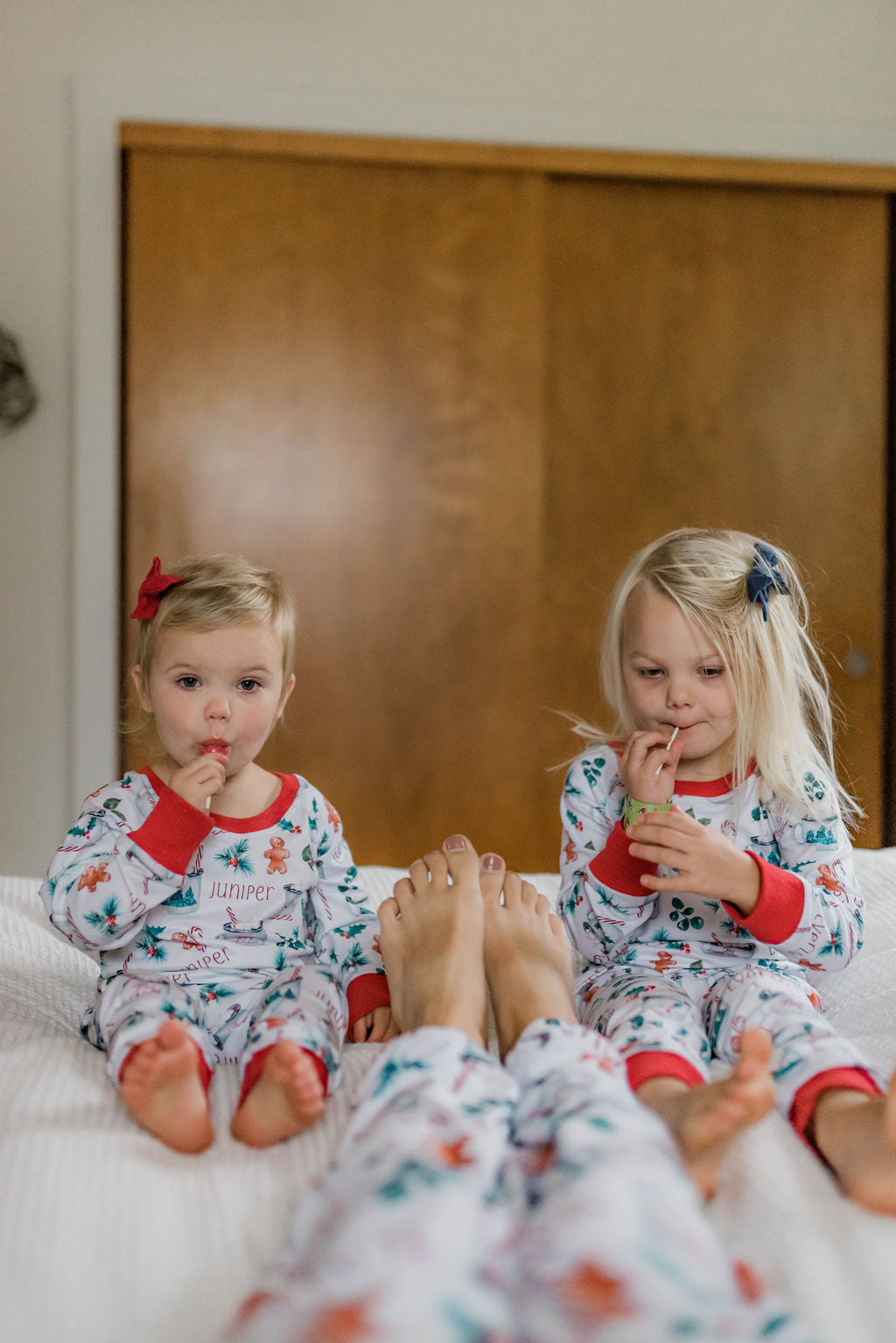 Two young girls wearing cute matching hot cocoa Christmas pajamas.