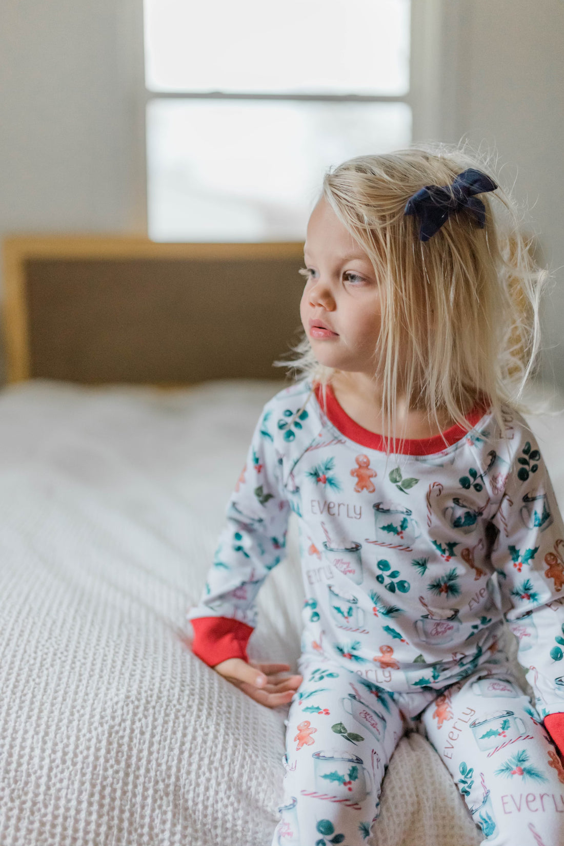 Young girl wearing personalized christmas hot chocolate pajamas.