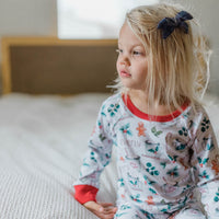 Young girl wearing personalized christmas hot chocolate pajamas.