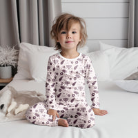 Child wearing pink girls Hanukkah pajamas.
