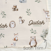 gender neutral woodland animal satin bound baby blanket personalized with babys name on an ivory background