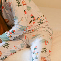 Child sitting in chair while wearing Ski Pajamas.