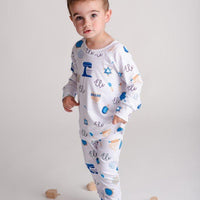 Child wearing kids Hanukkah pajamas.