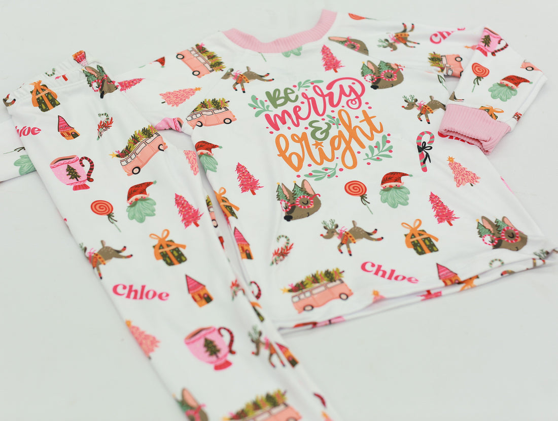 Merry & Bright colorful christmas jammies, with pink and green cartoon Holiday images such as trees, lollipops, Santa faces, candy canes and reindeer.