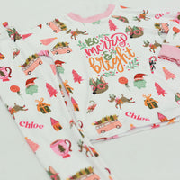 Merry & Bright colorful christmas jammies, with pink and green cartoon Holiday images such as trees, lollipops, Santa faces, candy canes and reindeer.