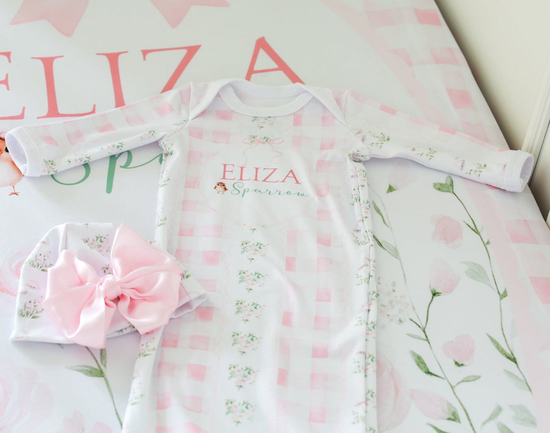 Baby outfit with floral design and matching headband on a pink floral background