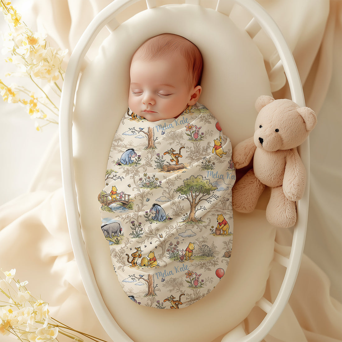 A baby swaddled in a blanket with Winnie the Pooh characters is sleeping in a white crib, accompanied by a teddy bear.