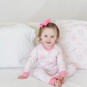 little girl wearing personalized baseball & bows light pink baseball theme pajamas