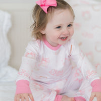 little girl wearing personalized baseball & bows light pink baseball theme pajamas