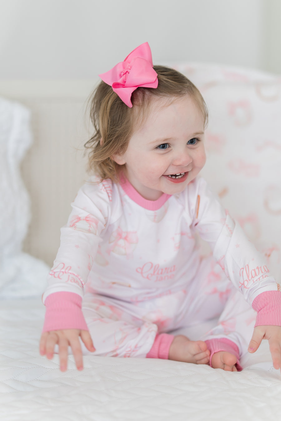 little girl wearing personalized baseball & bows light pink baseball theme pajamas