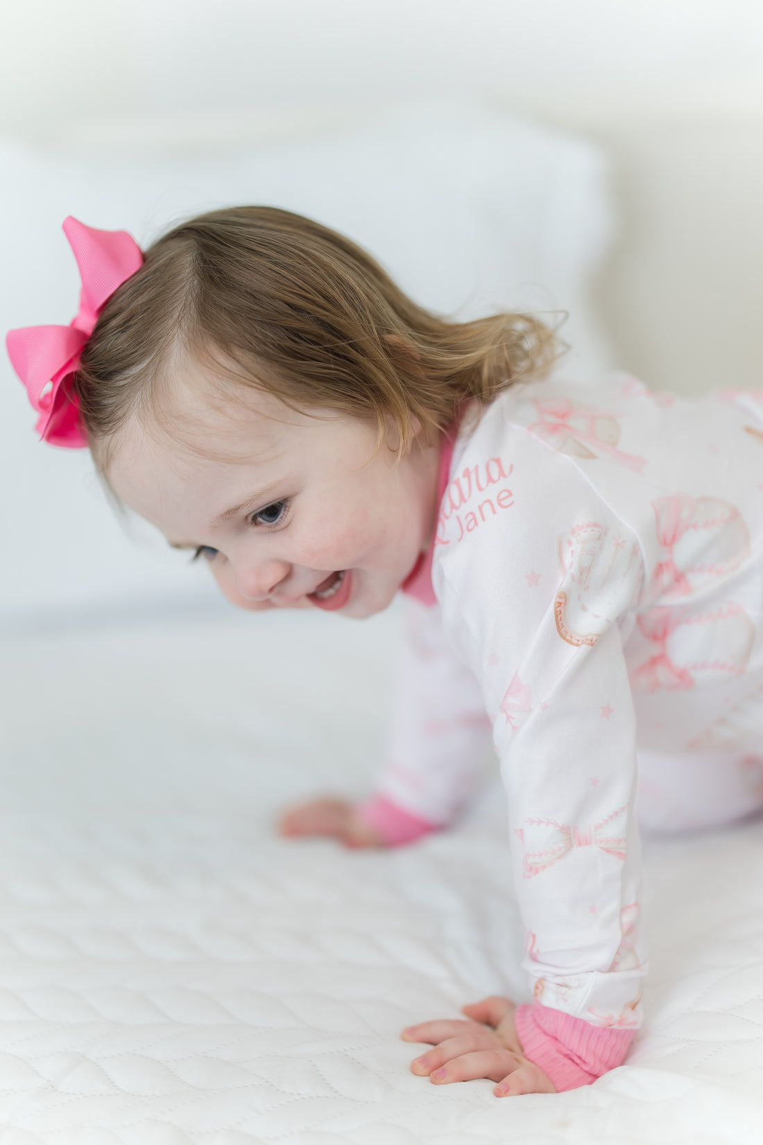 little girl wearing personalized baseball & bows light pink baseball theme pajamas