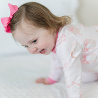 little girl wearing personalized baseball & bows light pink baseball theme pajamas