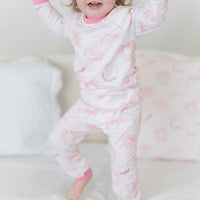 little girl wearing personalized baseball & bows light pink baseball theme pajamas