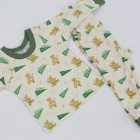 A pair of pajamas with a repeating pattern of green and white teddy bears on a white background.