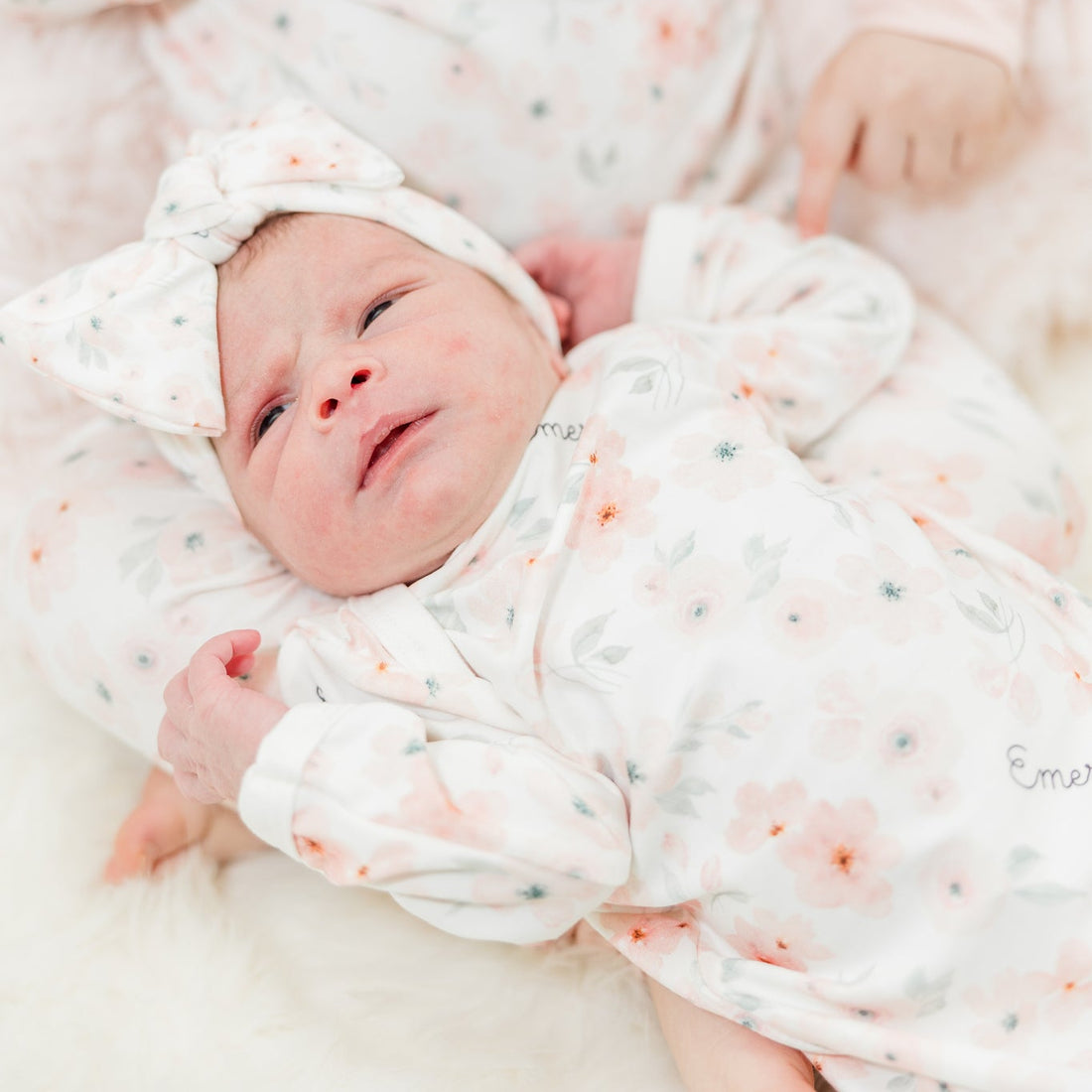 baby girl in peach blossom baby gown and matching headband, easy on and off outfit for newborn baby girl, personalized with baby's name and soft pink floral print