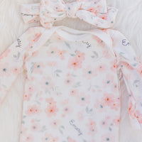 baby girl in peach blossom baby gown and matching headband, easy on and off outfit for newborn baby girl, personalized with baby's name and soft pink floral print