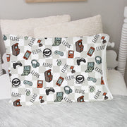 video gamer print personalized pillowcase for kids, light gray checkered background with gaming images such as remotes, consoles, headphones, and tablets in a sketched cartoon style with kid's name.