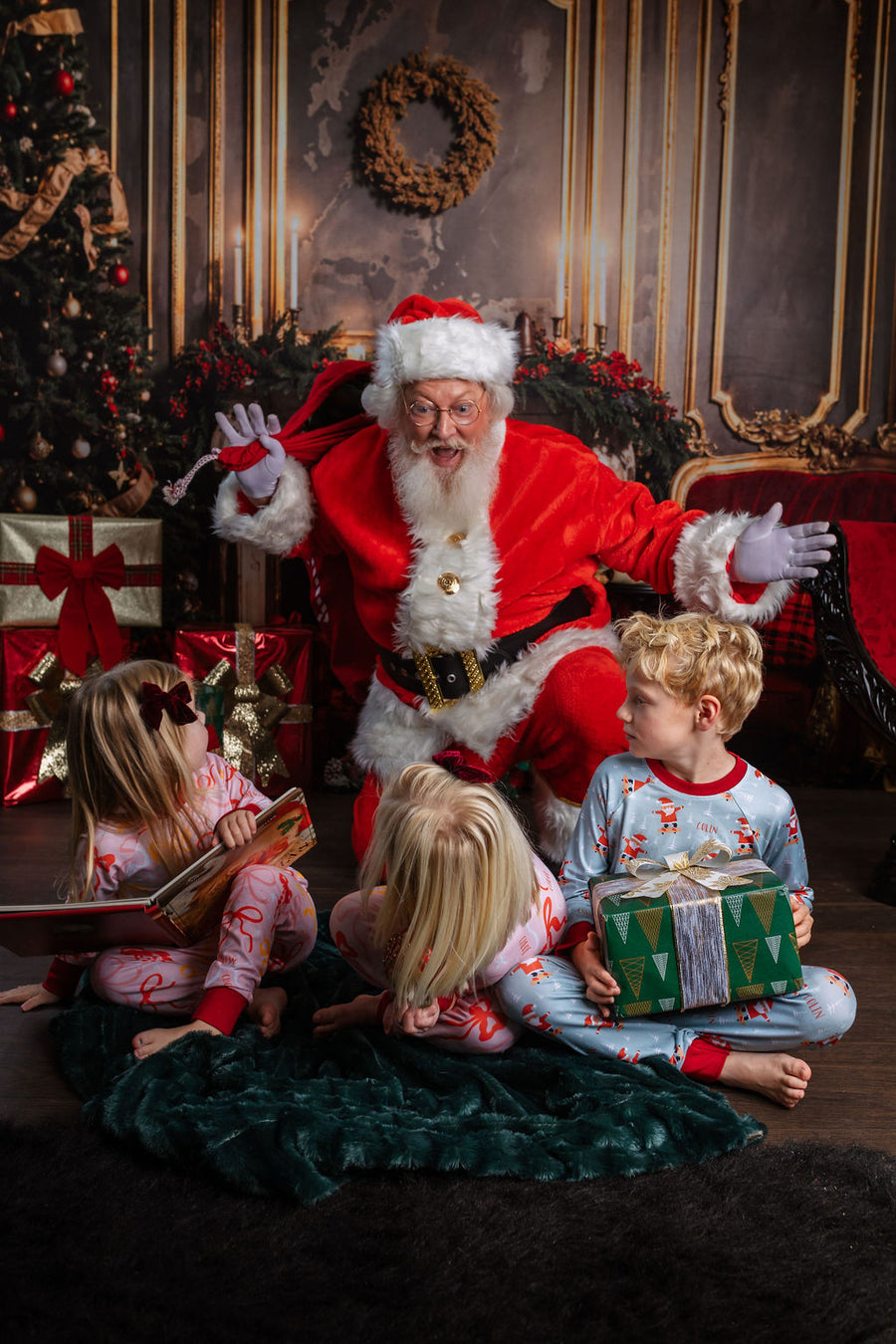 child wearing personalized christmas pajamas with santa on skateboards on blue background with red cuffs