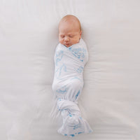 baby boy swaddled in blue western toile print white knit baby blanket with name