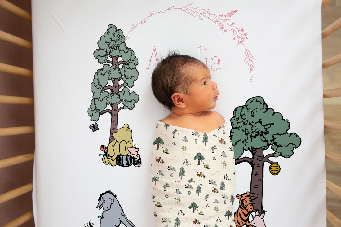 Baby Girl laying on Winnie The Pooh Crib Bedding