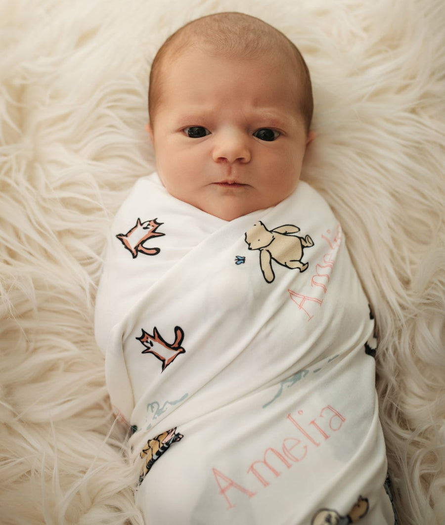 Pink lettering Saying Name on a Winnie The Pooh Swaddle Blankets